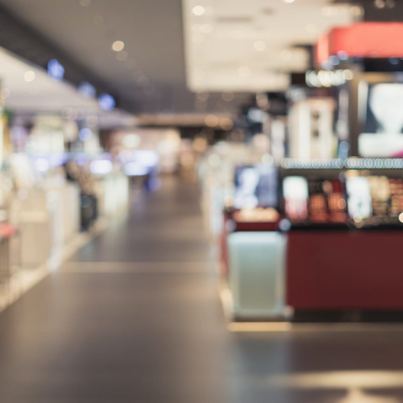 Abstract blurred image of cosmetics department in the mall